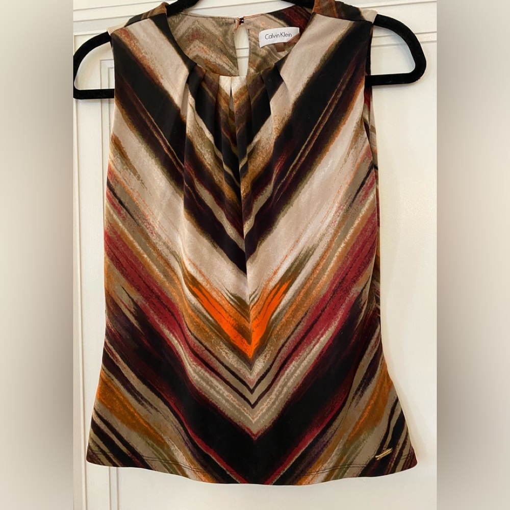 UEC Calvin Klein sleeveless top. One button in back. Size xs